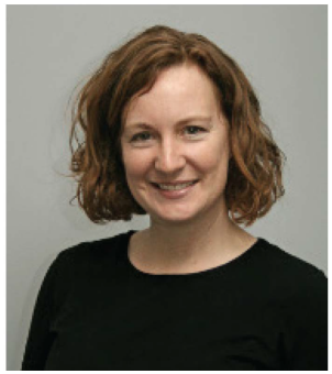 A smiling woman in a dark blouse